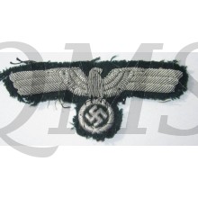 The eagle is nicely hand-embroidered using silver braid on a early style dark-green wool. The eagle is in good used and clearly cap removed condition.