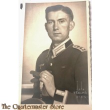 Studio portret german soldier sitting with sword WW2