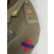 A four brass button tunic with lay down collar, integral button shoulder straps, scallop button flap breast pockets, watch fob pocket and large button flap patch pockets to the hips