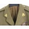 A four brass button tunic with lay down collar, integral button shoulder straps, scallop button flap breast pockets, watch fob pocket and large button flap patch pockets to the hips